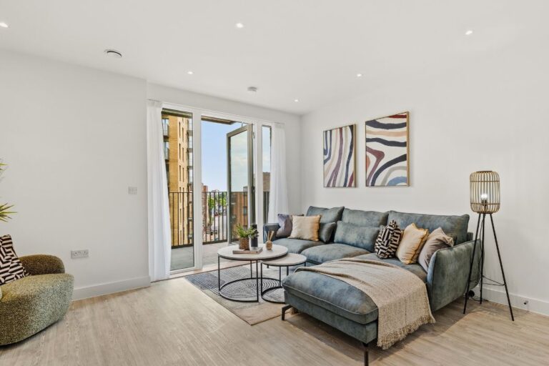 Open plan living area and doors onto balcony