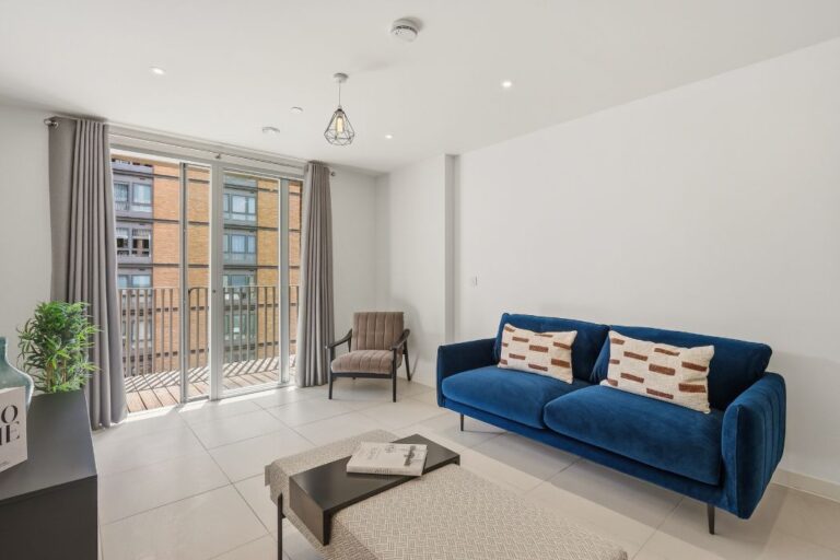 Open plan living area with balcony inside Rehearsal Rooms apartments in North Acton