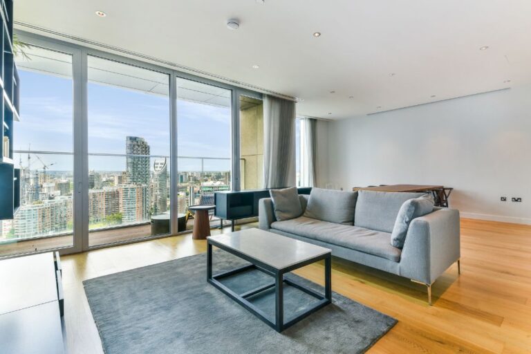 Living room with large windows and river views from Arora Tower apartment