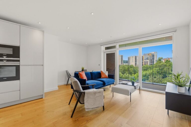Living space leading onto balcony overlooking gardens