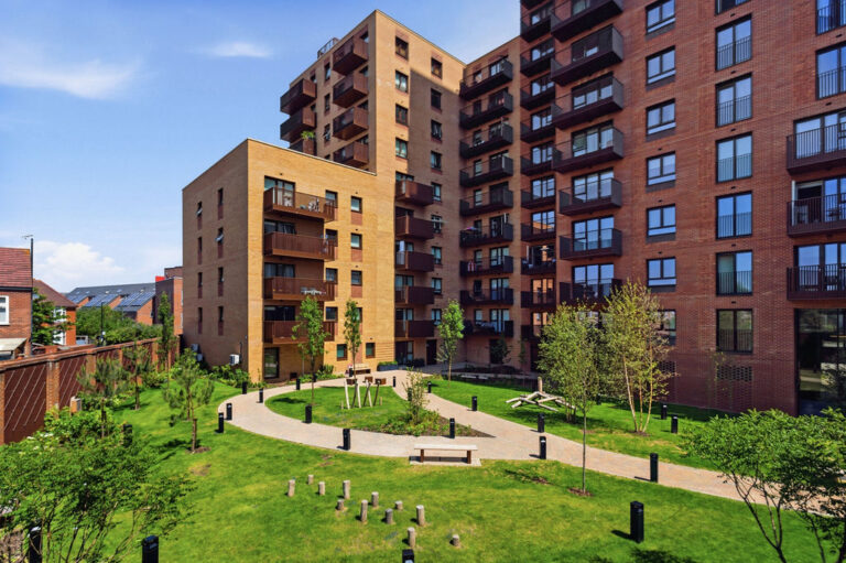 Landscaped outdoor courtyard and green spaces at Royal Gateway apartments in Acton
