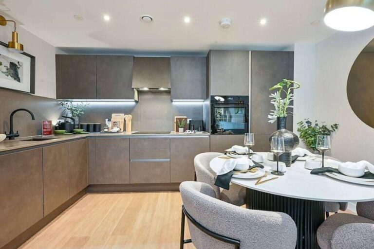 Contemporary fitted kitchen and dining area inside a Royal Gateway apartment
