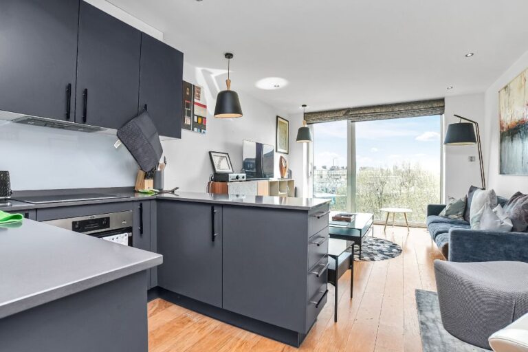 Modern open-plan kitchen and living space in a Maltings Place apartment.