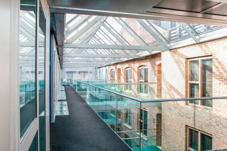 The glass atrium connecting apartments within the Maltings Place development in SE1.