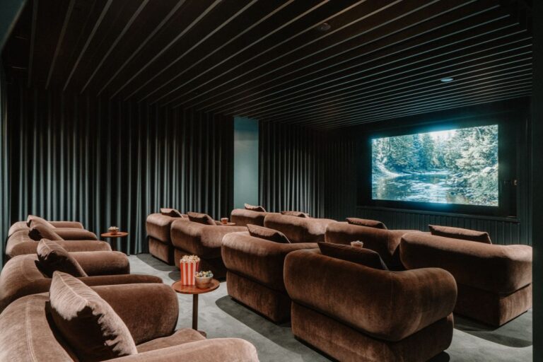 Resident cinema room with large screen and lounge seating