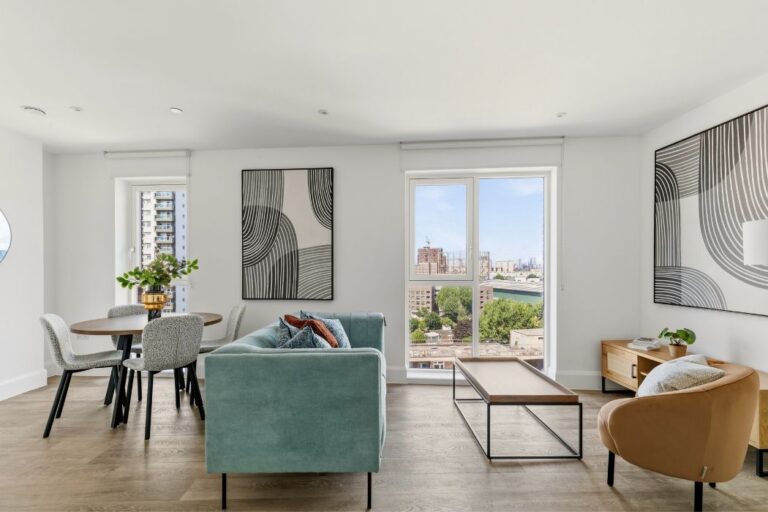 Open plan living and dining area with doors out to balcony