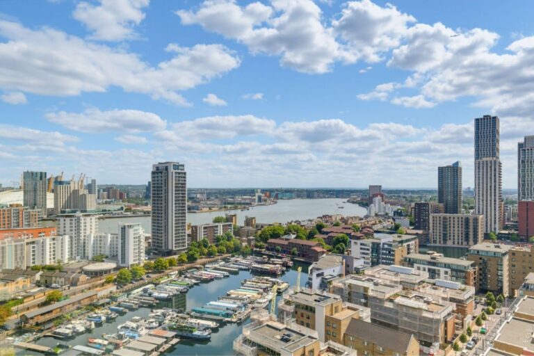 View from a Wharf House apartment overlooking Canary Wharf, South Dock and the River Thames.