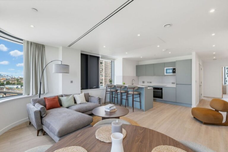Bright open-plan living and kitchen area with large windows at Wharf House.