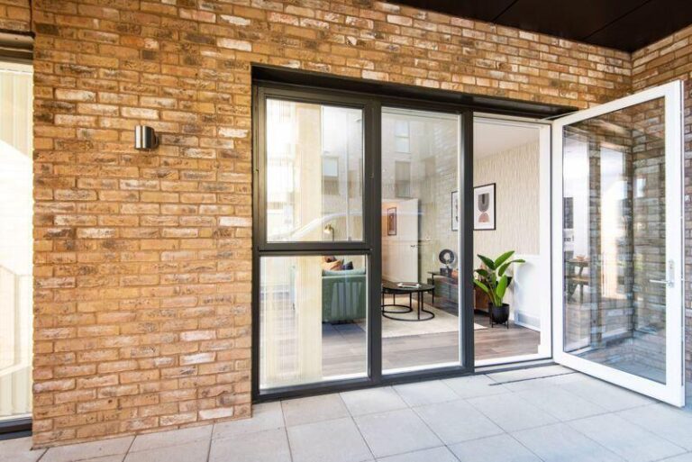 Private covered balcony accessed directly from an apartment at Rally Building