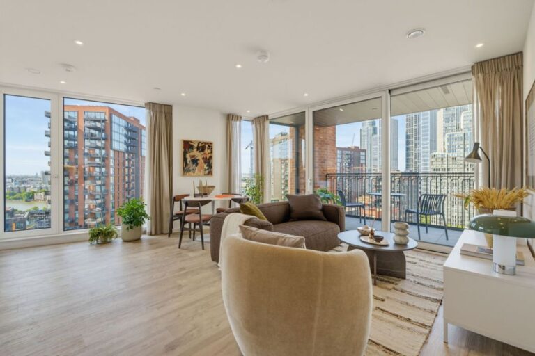 Bright open-plan living and dining area at Apex One with access to a private balcony