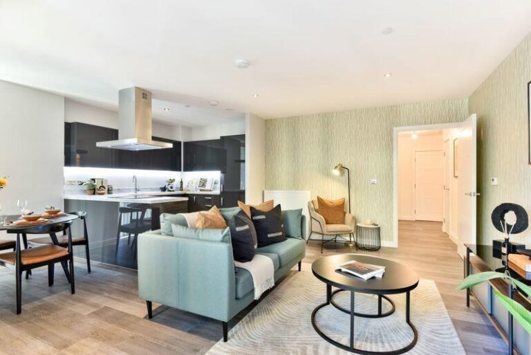 Open-plan living, dining and kitchen area inside an apartment at Rally Building