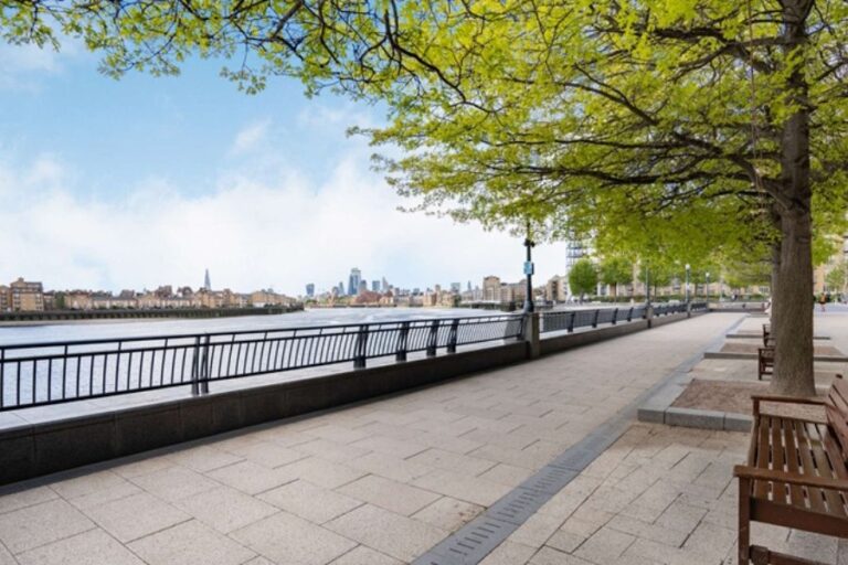 Riverside walkway beside the River Thames near Circus Apartments in Canary Wharf