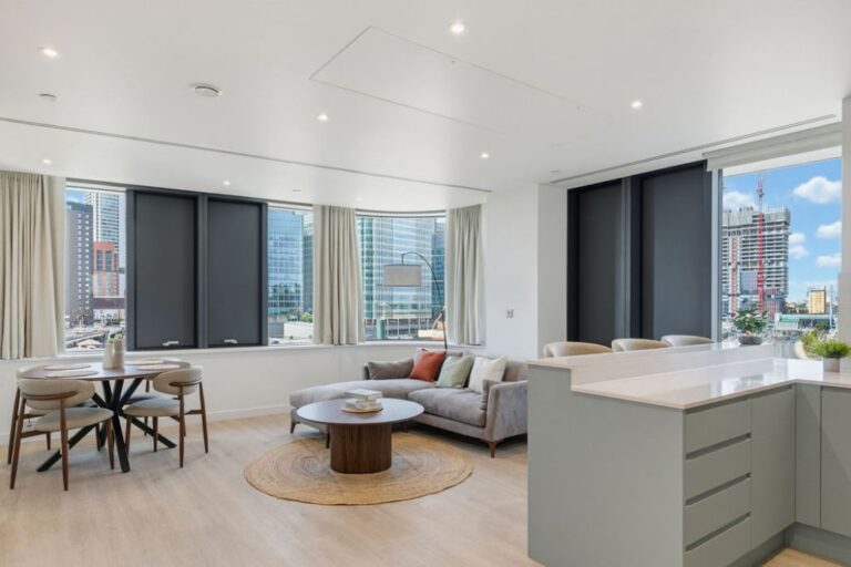 Spacious open-plan apartment with dining area and views across Canary Wharf.