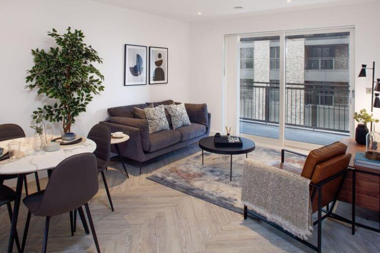 Open-plan living and dining room with doors leading onto a private balcony