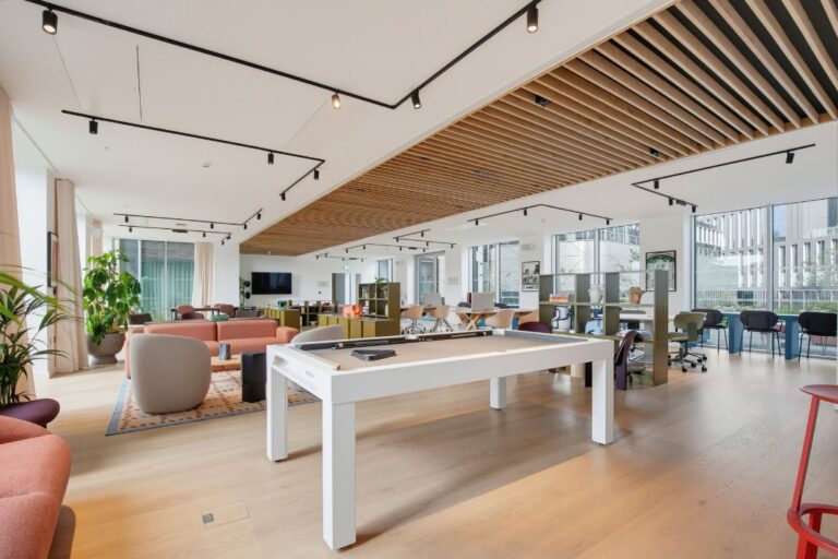 Spacious residents' lounge with seating, pool table and co-working areas