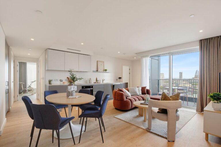 Open-plan kitchen, dining and living space with private balcony at Lumina House
