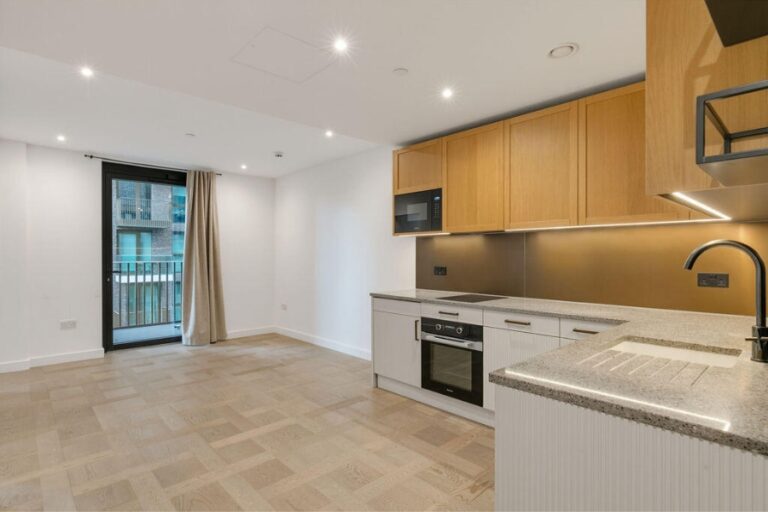 Open-plan kitchen and living area with integrated appliances at 4 Merino Gardens